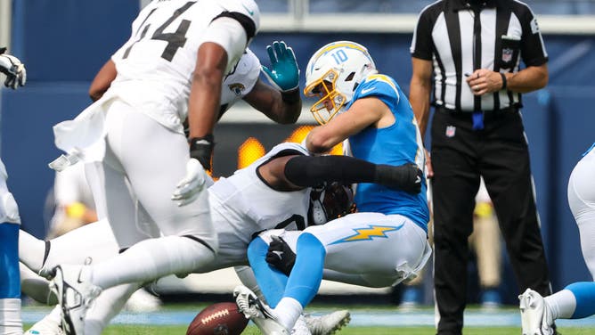 Los Angeles Chargers QB Justin Herbert fumbles the ball while being sacked by the Jacksonville Jaguars at SoFi Stadium in Los Angeles.
