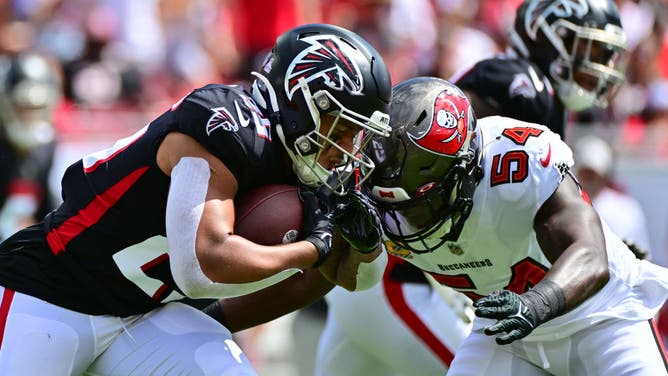 Buccaneers LB Lavonte David tackles Falcons RB Tyler Allgeier at Raymond James Stadium in Tampa.