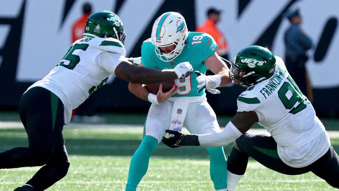 Quinnen Williams and John Franklin-Myers of the New York Jets sack Skylar Thompson of the Miami Dolphins.