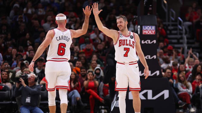 Chicago Bulls PGs Alex Caruso and Goran Dragic celebrate a basket against the Milwaukee Bucks at United Center in Chicago.