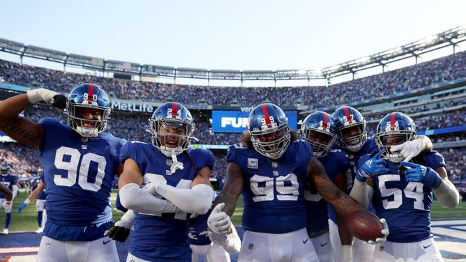 The New York Giants' defensive line celebrates after recovering a fumble in the fourth quarter against the Baltimore Ravens at MetLife Stadium in East Rutherford, New Jersey.