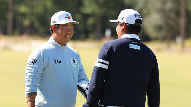 South Koreans Tom Kim and Sungjae Im converse on the range during a pro-am prior to The CJ Cup at Congaree Golf Club in Ridgeland, South Carolina.