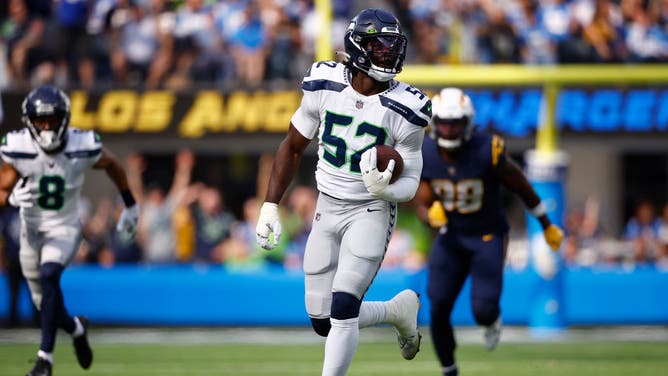 Seattle Seahawks player Darrell Taylor joins play from sidelines.