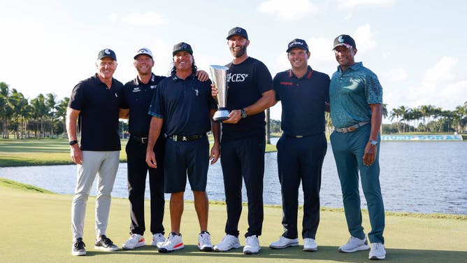 Greg Norman, CEO and commissioner of LIV Golf, Talor Gooch, Pat Perez, Team Captain Dustin Johnson and Patrick Reed of 4 Aces GC and Majed Al Sorour, CEO of Saudi Golf Federation, celebrate with the championship trophy after winning during the team championship stroke-play round of the LIV Golf Invitational - Miami at Trump National Doral Miami on October 30, 2022.