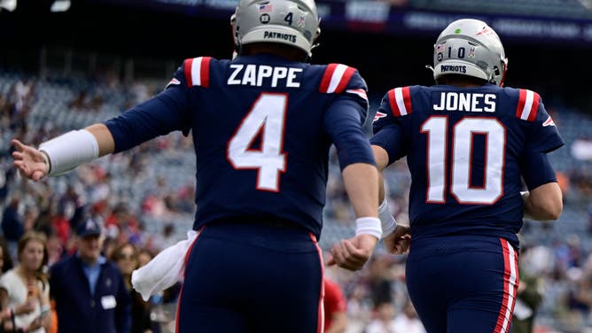 New England Patriots quarterbacks Bailey Zappe and Mac Jones take to the field before a game against the Indianapolis Colts at Gillette Stadium in Foxborough, Massachusetts.