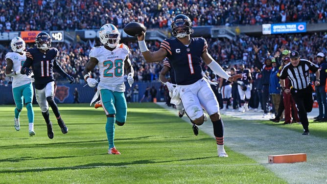 QB Justin Fields scores a touchdown against the Dolphins on NFL Sunday.