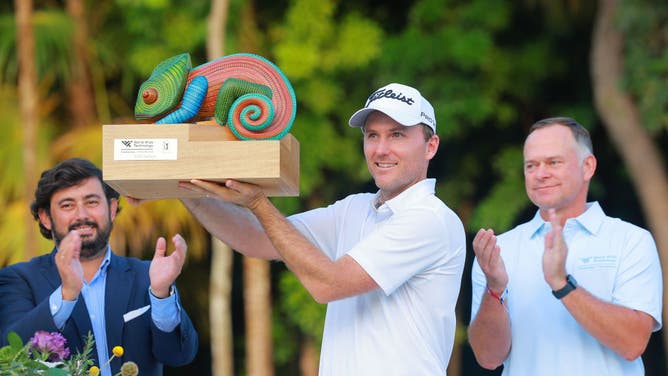 Russell Henley holds the trophy after winning the 2022 World Wide Technology Championship at Club de Golf El Camaleon in Playa del Carmen.