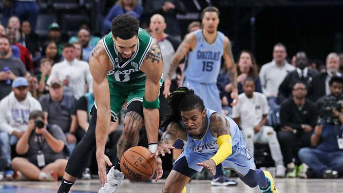 Grizzlies' PG Ja Morant and Celtics' Jayson Tatum go after a loose ball at FedExForum in Memphis, Tennessee.