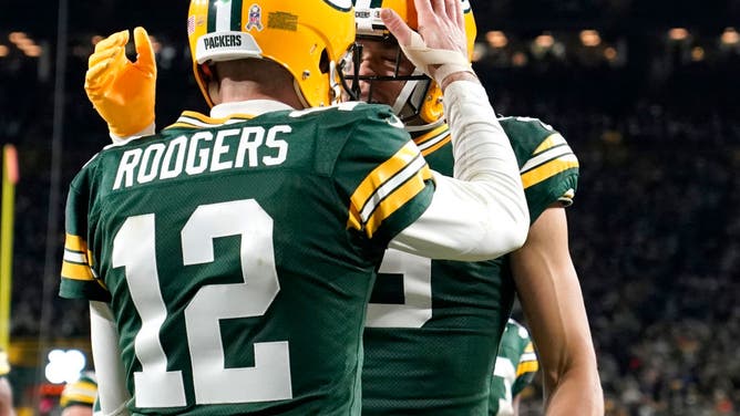 Green Bay Packers QB Aaron Rodgers and WR Christian Watson celebrate a touchdown against the Dallas Cowboys.