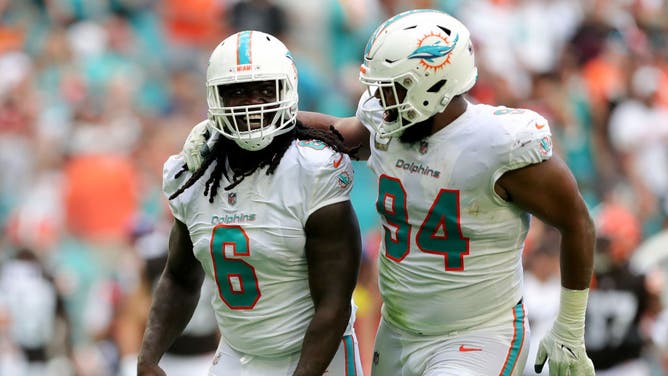 Miami Dolphins defensive linemen Melvin Ingram and Christian Wilkins celebrate after a sack against the Cleveland Browns at Hard Rock Stadium in Miami.
