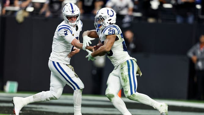 Indianapolis Colts QB Matt Ryan hands off to RB Jonathan Taylor during an NFL game between the Las Vegas Raiders and the Indianapolis Colts at Allegiant Stadium in Las Vegas.