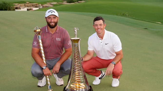 Jon Rahm and Rory McIlroy pose with their trophies during Day Four of the DP World Tour Championship on the Earth Course at Jumeirah Golf Estates in Dubai, United Arab Emirates.