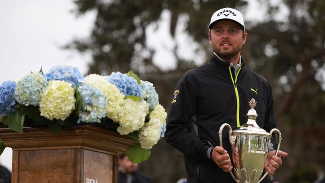 Adam Svensson poses with the trophy after winning the 2022 RSM Classic at Sea Island Golf Club's Seaside Course in St Simons Island, Georgia.