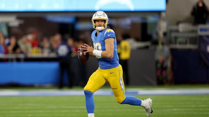 Los Angeles Chargers QB Justin Herbert scrambles during the first quarter in the game against the Kansas City Chiefs at SoFi Stadium in Inglewood, California.