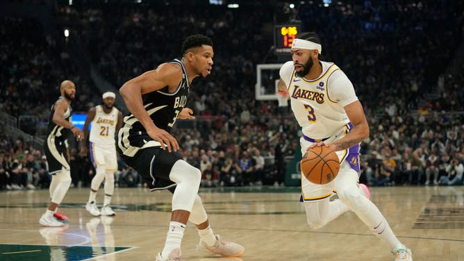 Los Angeles Lakers PF Anthony Davis dribbles the ball against Milwaukee Bucks PF Giannis Antetokounmpo at Fiserv Forum in Milwaukee, Wisconsin.
