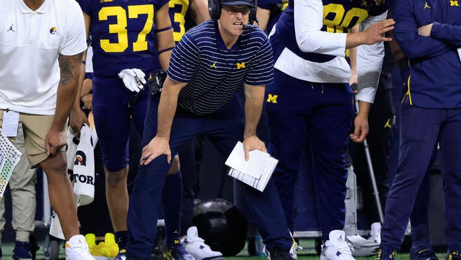 Michigan Wolverines head coach Jim Harbaugh watches his team during the 2nd half in the Big Ten Championship against the Purdue Boilermakers at Lucas Oil Stadium in Indianapolis.