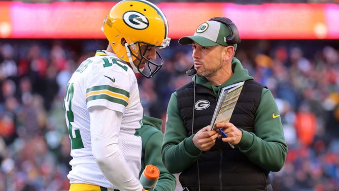 Aaron Rodgers of the Green Bay Packers and head coach Matt LaFleur talk during a game against the Chicago Bears.