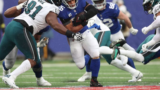New York Giants RB Saquon Barkley runs the ball against Philadelphia Eagles DT Fletcher Cox at MetLife Stadium in East Rutherford, New Jersey.