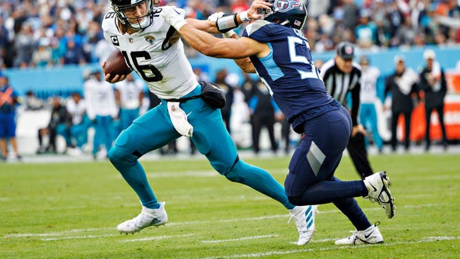 Jacksonville Jaguars QB Trevor Lawrence avoids the tackle of Tennessee Titans LB Dylan Cole on a TD run at Nissan Stadium in Nashville, Tennessee.