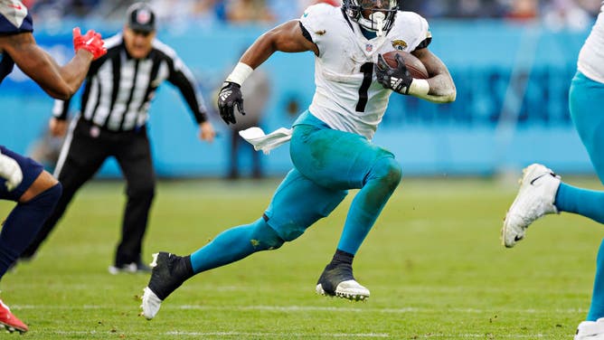 Jacksonville Jaguars RB Travis Etienne Jr. runs the ball during a game against the Tennessee Titans at Nissan Stadium in Nashville, Tennessee.