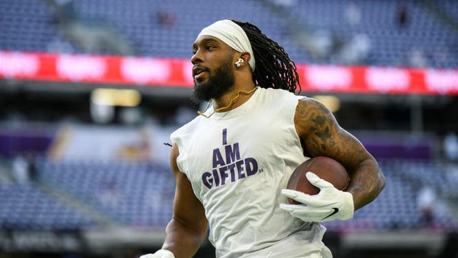 Alexander Mattison of the Minnesota Vikings warms up before a game.