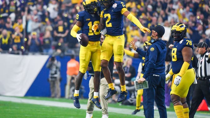 Michigan Wolverines safety Rod Moore and CB Will Johnson celebrate an interception vs. the TCU Horned Frogs at State Farm Stadium in Glendale, Arizona.