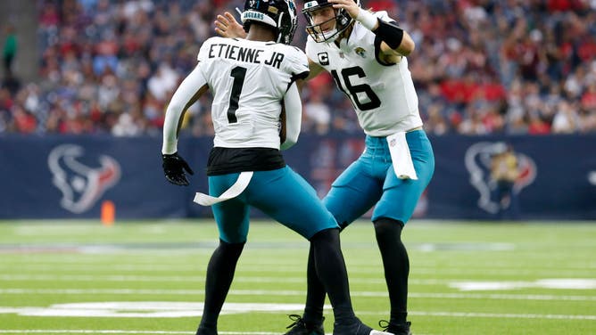 Jaguars RB Travis Etienne Jr. celebrates with Lawrence after rushing for a TD vs. the Texans at NRG Stadium in Houston, Texas.