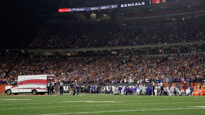 Fans look on as the ambulance leaves carrying Damar Hamlin of the Buffalo Bills after he collapsed after making a tackle against the Cincinnati Bengals on January 02, 2023.