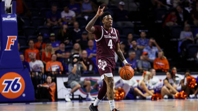 Texas A&M Aggies G Wade Taylor IV dribbles the ball against the Florida Gators at the Stephen C. O'Connell Center in Gainesville, Florida.