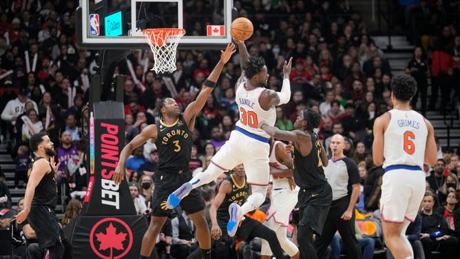 New York Knicks F Julius Randle passes the ball off against Toronto Raptors F OG Anunoby at the Scotiabank Arena in Toronto, Ontario, Canada.