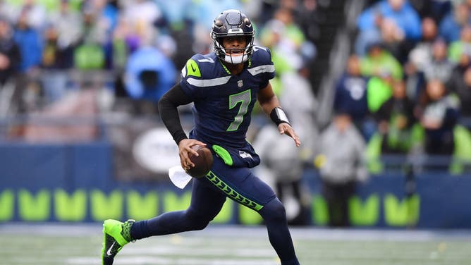 Seattle Seahawks QB Geno Smith scrambles with the ball during the 1st quarter against the Los Angeles Rams at Lumen Field in Seattle, Washington.
