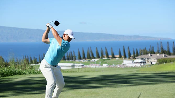 Tom Kim his a tee shot at the 18th hole in the Sentry Tournament of Champions 2023 at Kapalua Golf Club in Lahaina, Hawaii.