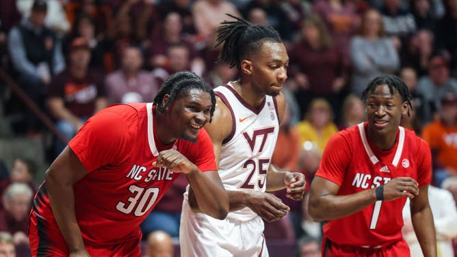 NC State F D.J. Burns Jr. and G Jarkel Joiner line up along the paint during a free-throw attempt with Virginia Tech F Justyn Mutts during a game at Cassell Coliseum in Blacksburg, Virginia.