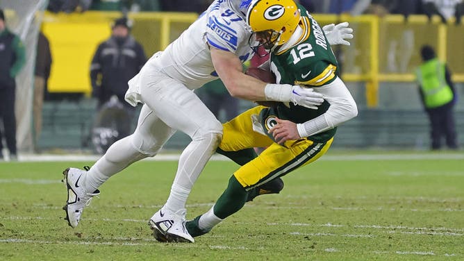 Then-Packers QB Aaron Rodgers is sacked by Detroit Lions edge rusher Aidan Hutchinson at Lambeau Field in Green Bay, Wisconsin.