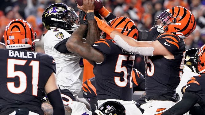 Baltimore Ravens QB Tyler Huntley fumbles the ball that is recovered by Cincinnati Bengals DE Sam Hubbard to score a 98-yard TD in the AFC Wild Card playoff game at Paycor Stadium in Cincinnati, Ohio.