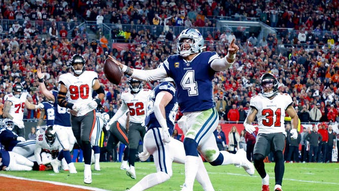 Dallas Cowboys QB Dak Prescott rushes for a TD against the Tampa Bay Buccaneers during the NFC Wild Card playoff game at Raymond James Stadium in Tampa, Florida.