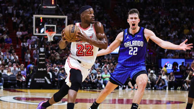 Jimmy Butler drives past Magic wing Franz Wagner at Miami-Dade Arena in Miami.