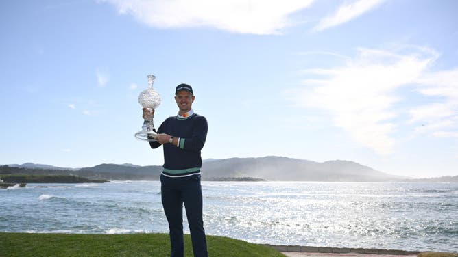 Justin Rose poses with the trophy after winning the 2023 AT&T Pebble Beach Pro-Am at Pebble Beach Golf Links in California.