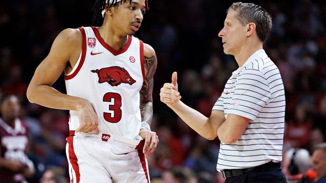Arkansas G Nick Smith Jr. talks with coach Eric Musselman during a game vs. the Mississippi State Bulldogs at Bud Walton Arena in Fayetteville, Arkansas.