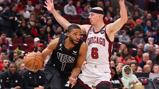 Brooklyn Nets wing Mikal Bridges drives to the basket on Bulls SG Alex Caruso at United Center in Chicago.