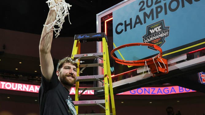 Gonzaga Bulldogs big Drew Timme cuts down a net after Gonzaga's 77-51 victory over the Saint Mary's Gaels to win the West Coast Conference championship at the Orleans Arena in Las Vegas.