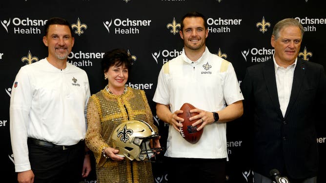 Saints coach Dennis Allen, owner Gayle Benson, general manager Mickey Loomis and Derek Carr pose for a picture at New Orleans Saints Indoor Practice Facility in Louisiana.