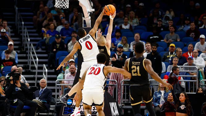 San Diego State Aztecs PG Keshad Johnson blocks a Charleston Cougar in the 1st round of the 2023 NCAA Tournament at Amway Center in Orlando, Florida.
