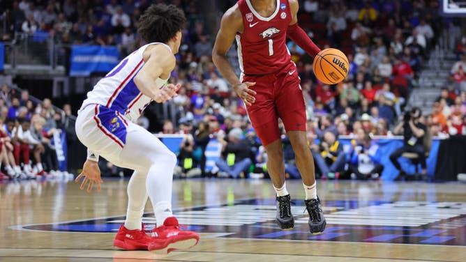 Arkansas guard Ricky Council IV dribbles the ball against Kansas Jayhawks SF Jalen Wilson in the NCAA Basketball Tournament at Wells Fargo Arena in Des Moines, Iowa.