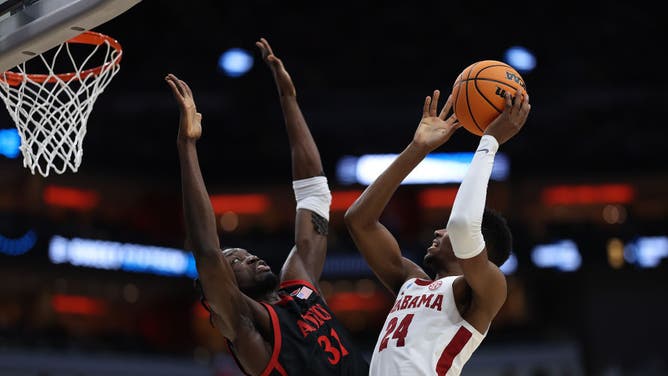 Mensah meets Alabama wing Brandon Miller at the rim in the Sweet 16 round of the 2023 NCAA Tournament at KFC YUM! Center in Louisville, Kentucky.