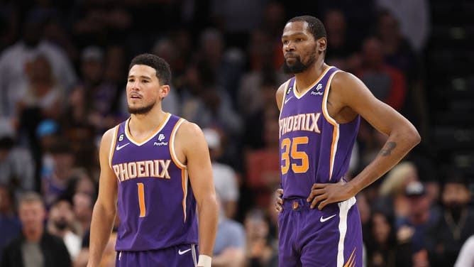Suns' Devin Booker and Durant wait on court during a timeout vs. the Minnesota Timberwolves at Footprint Center in Phoenix, Arizona.