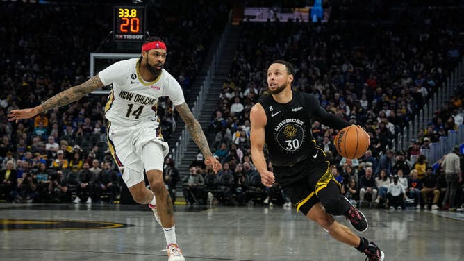 Golden State Warriors' Stephen Curry drives to the hoop on New Orleans Pelicans wing Brandon Ingram in an NBA game at Chase Center in San Francisco.