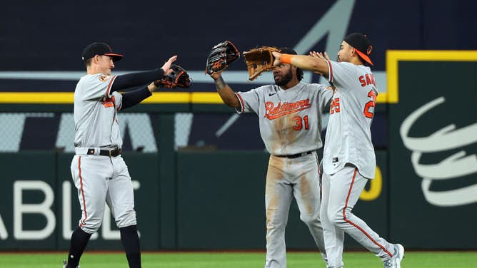 Orioles' Austin Hays, Cedric Mullins, and Anthony Santander celebrate the win over the Rangers at Globe Life Field in Arlington, Texas.