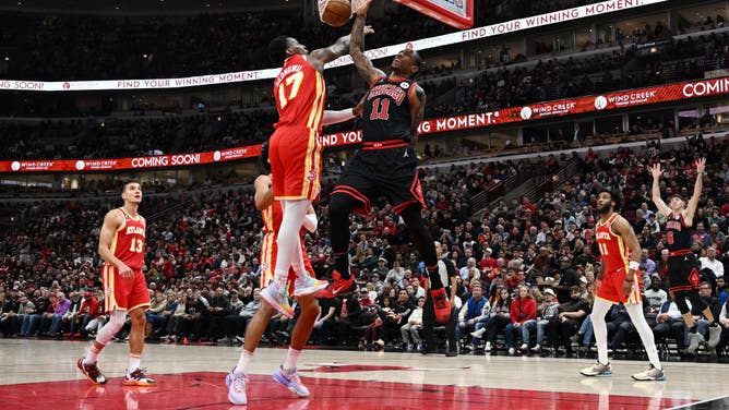 Bulls SF DeMar DeRozan dunks the ball on Atlanta Hawks big Onyeka Okongwu at United Center in Chicago.