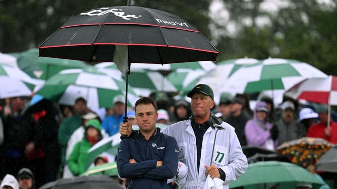 Justin Thomas and his caddie Jim 'Bones' Mackay react to his bogey on the 18th green during the 2nd round of the 2023 Masters Tournament at Augusta in Georgia.